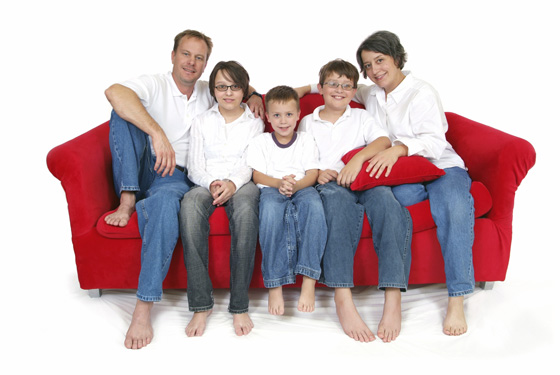 Red sofa with happy family, including mum.
